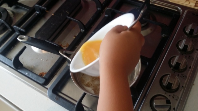 egg poured on frypan